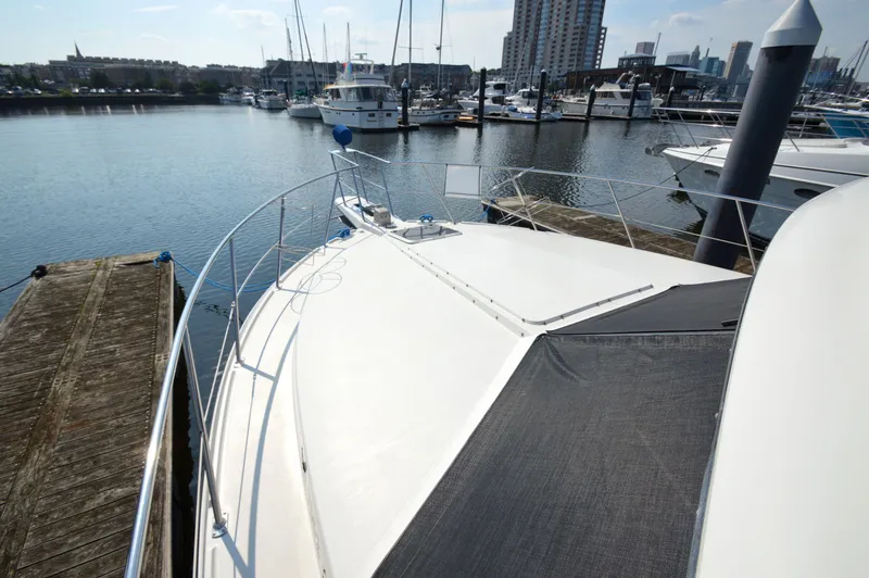 Slide: The Image of 1991 Carver 43 Cockpit Motoryacht docked in a marina with city skyline. - 30
