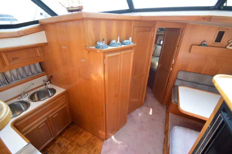 Slide: The Image of Interior of 1991 Carver 43 Cockpit Motoryacht with wood cabinetry and dual sinks. - 35