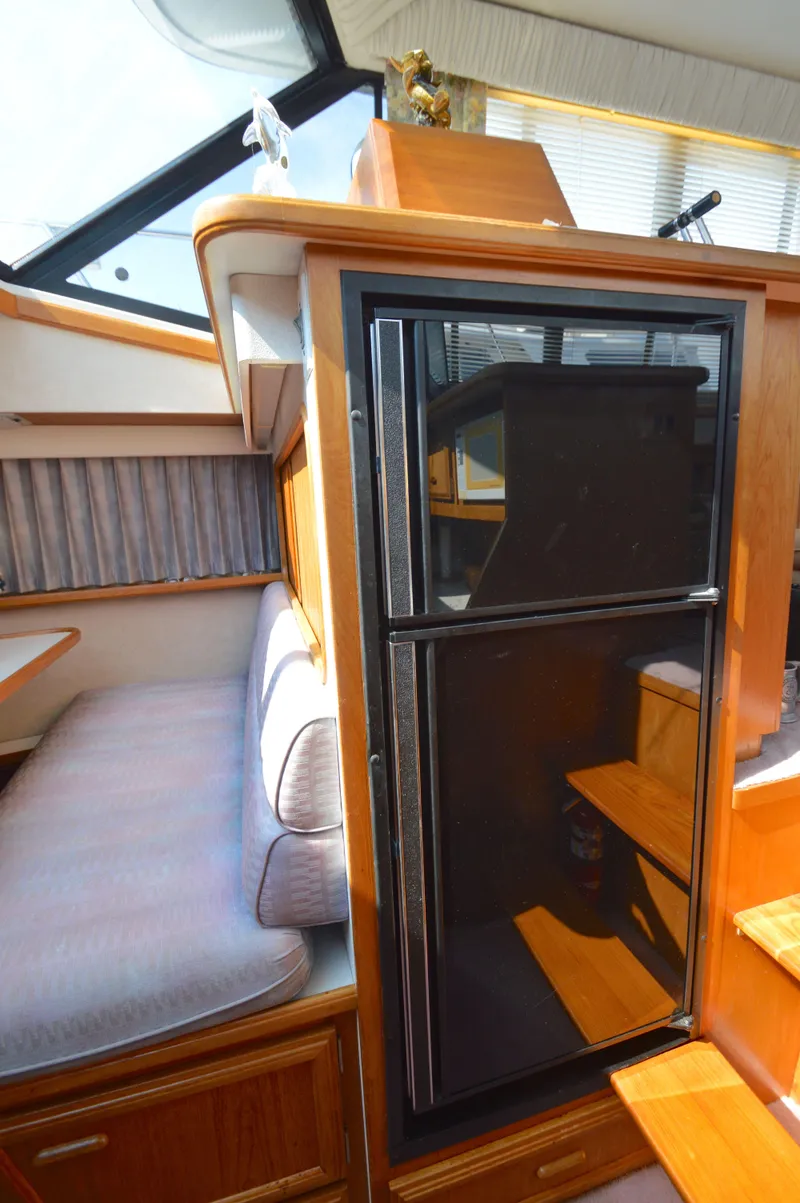 Slide: The Image of Interior of 1991 Carver 43 Cockpit Motoryacht with seating and refrigerator. - 38