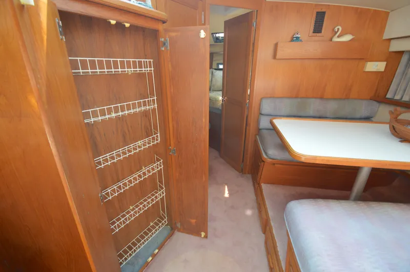 Slide: The Image of Interior of 1991 Carver 43 Cockpit Motoryacht with dining area and storage. - 40