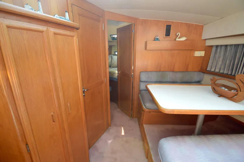 Slide: The Image of Interior of 1991 Carver 43 Cockpit Motoryacht with wood paneling and dining area. - 41