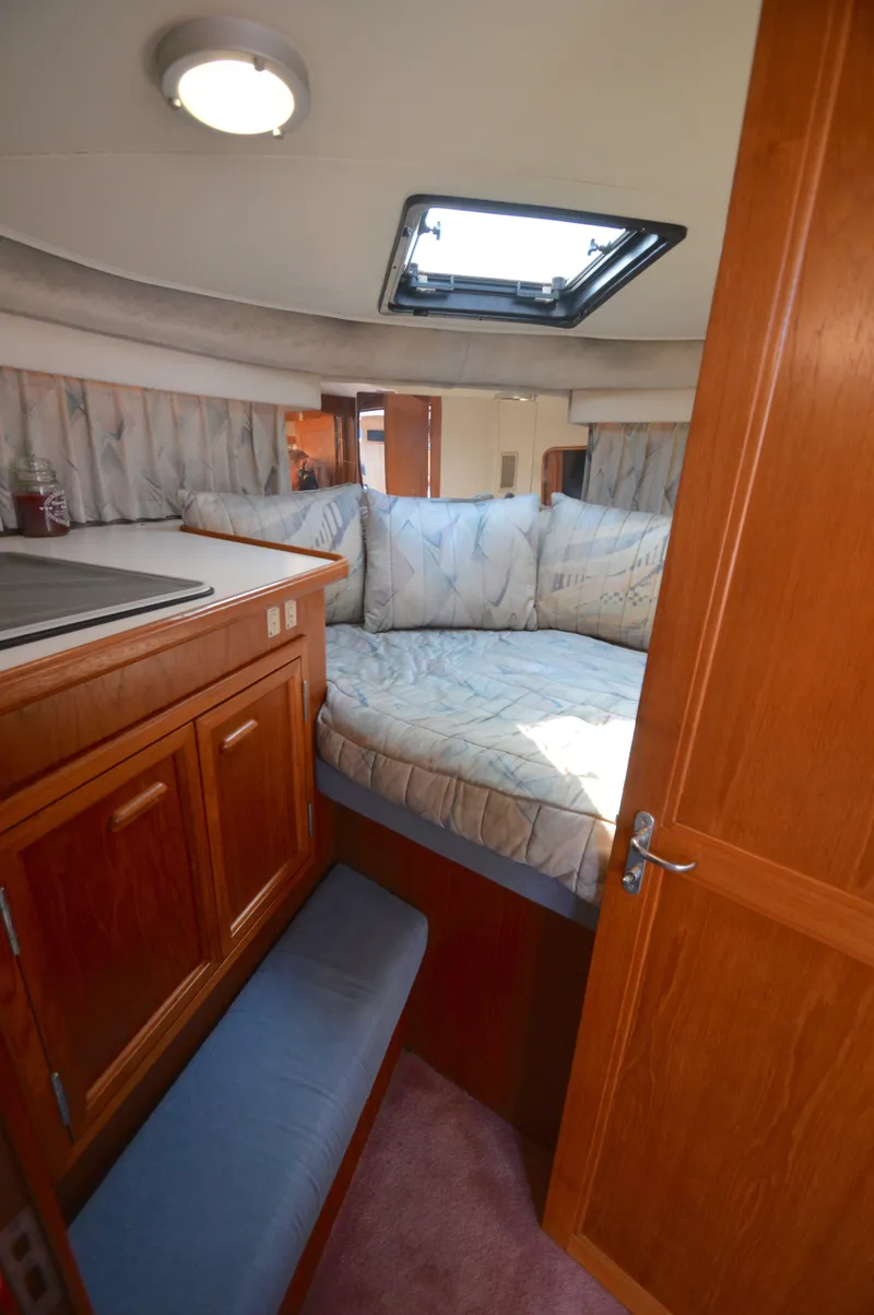 Slide: The Image of Interior of 1991 Carver 43 Cockpit Motoryacht with cozy bed and wooden cabinetry. - 45