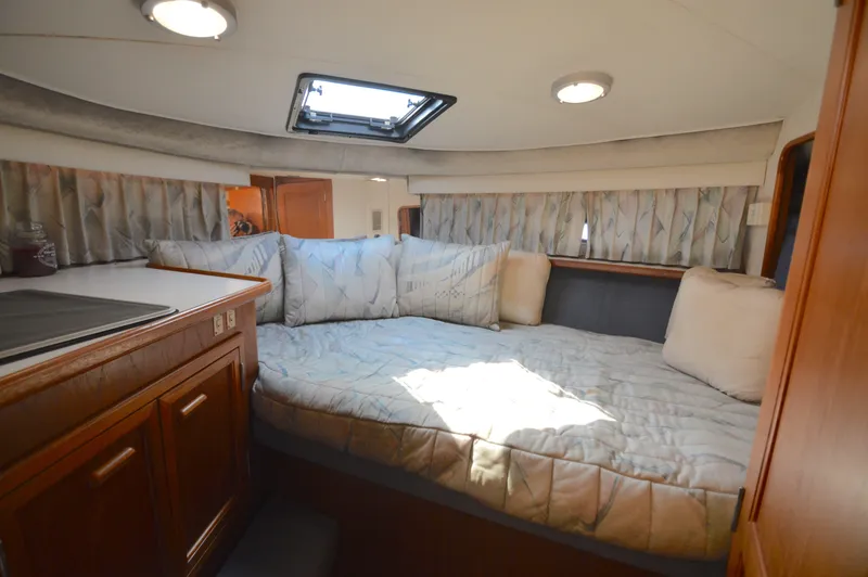Slide: The Image of Cozy bedroom in 1991 Carver 43 Cockpit Motoryacht with natural light and plush bedding. - 46