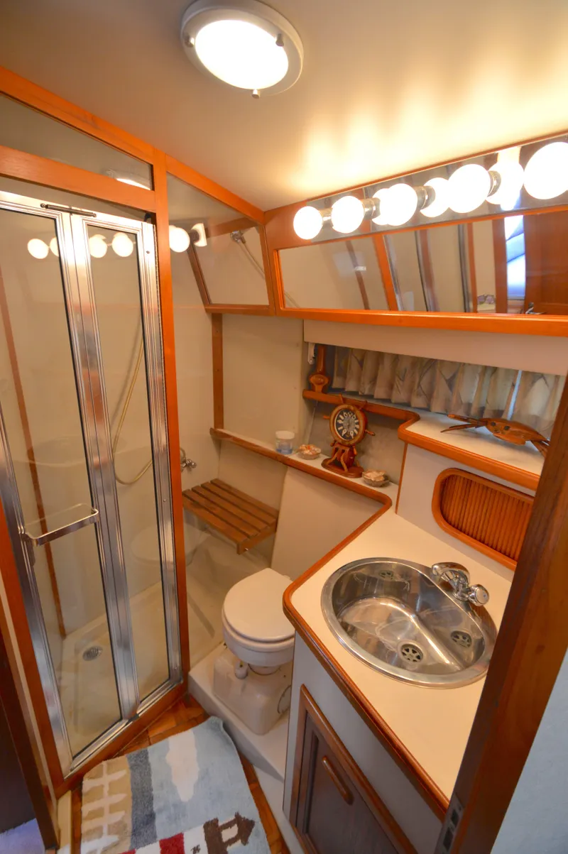 Slide: The Image of Luxurious bathroom in 1991 Carver 43 Cockpit Motoryacht with shower, sink, and nautical decor. - 47