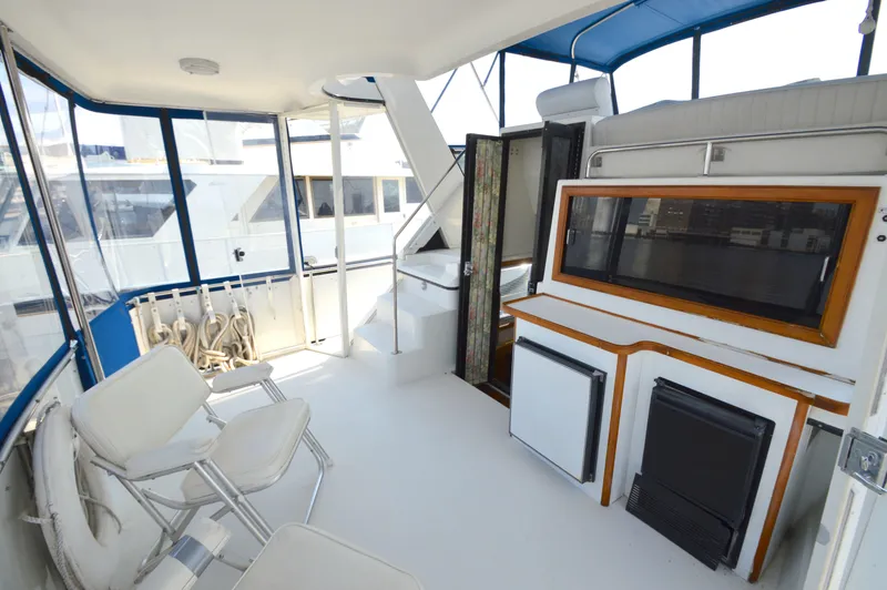 Slide: The Image of 1991 Carver 43 Cockpit Motoryacht interior with seating and storage. - 5