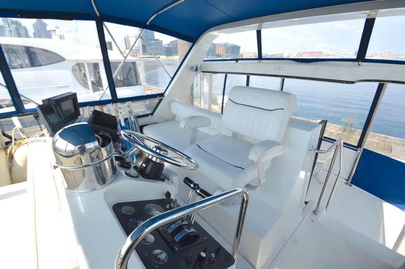 Slide: The Image of Interior of 1991 Carver 43 Cockpit Motoryacht with steering wheel and captain's chair. - 9
