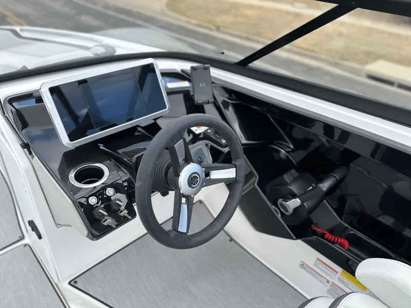 Slide: The Image of 2025 Yamaha Boats AR250 dashboard with steering wheel and touchscreen display. - 10