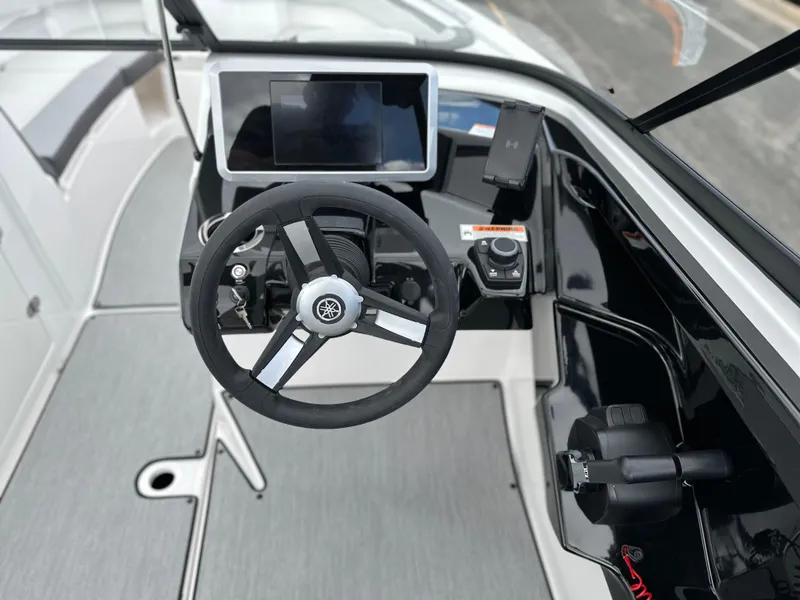 Slide: The Image of 2025 Yamaha Boats AR250 dashboard with steering wheel and digital display. - 12