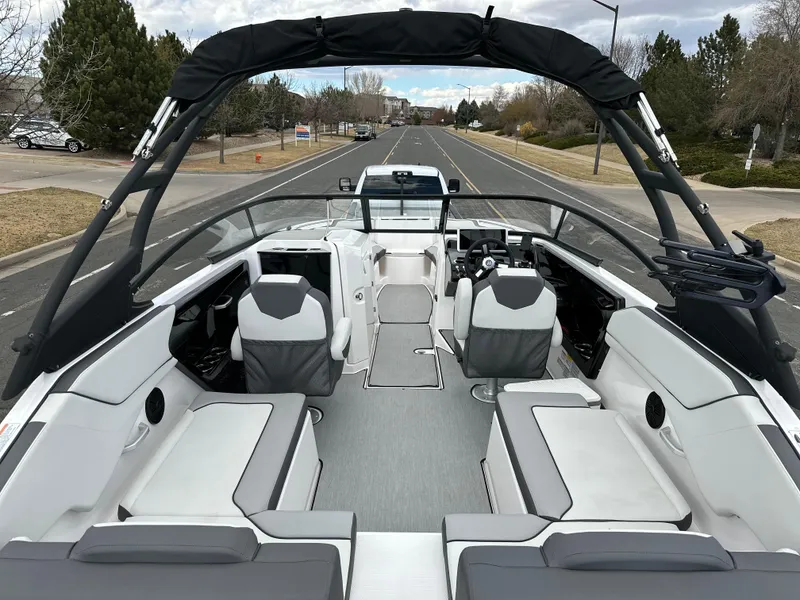 Slide: The Image of 2025 Yamaha Boats AR250 interior with sleek seating and modern design on a road. - 17