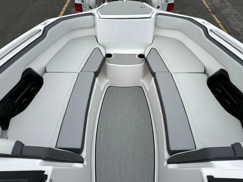 Slide: The Image of 2025 Yamaha Boats AR250 interior with gray seating and cup holders. - 7