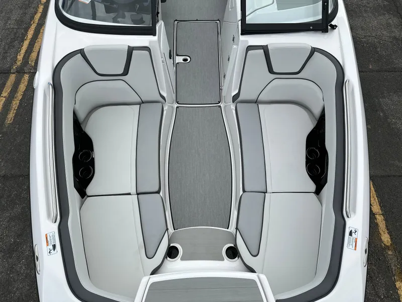 Slide: The Image of 2025 Yamaha Boats AR250 interior with gray seating and cup holders. - 8