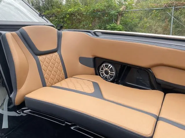 Slide: The Image of Luxurious tan and black seating in 2025 Yamaha Boats 255XD with built-in speaker. - 12