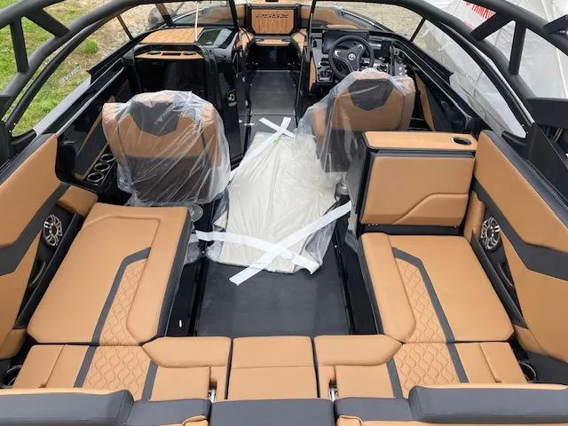 Slide: The Image of 2025 Yamaha Boats 255XD interior with tan and black seating, showcasing modern design and spacious layout. - 4