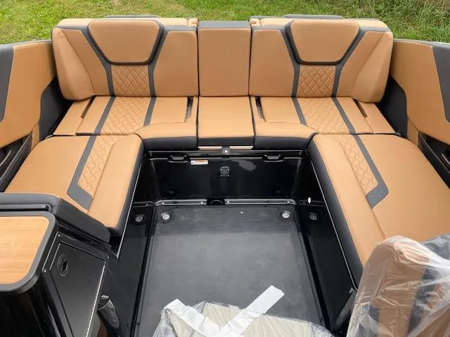 Slide: The Image of 2025 Yamaha Boats 255XD interior with tan and black seating, showcasing modern design and comfort. - 5