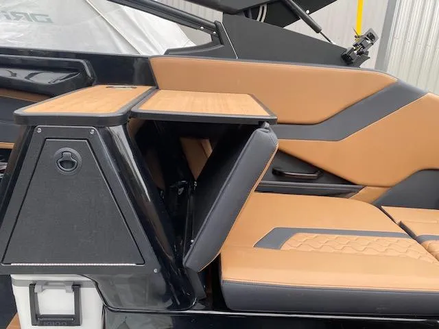 Slide: The Image of 2025 Yamaha Boats 255XD interior with tan and black seating and foldable table. - 7