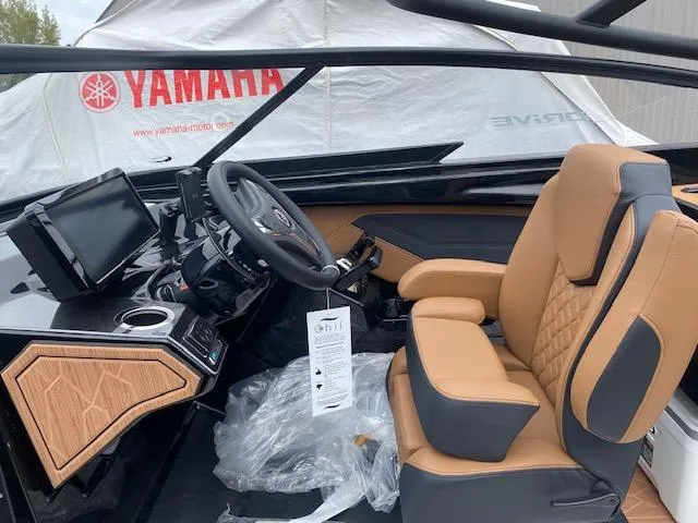 Slide: The Image of 2025 Yamaha Boats 255XD interior with tan leather seating and modern dashboard. - 8