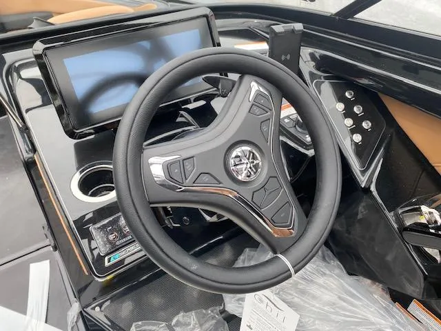 Slide: The Image of 2025 Yamaha Boats 255XD steering wheel and dashboard with touchscreen display. - 9