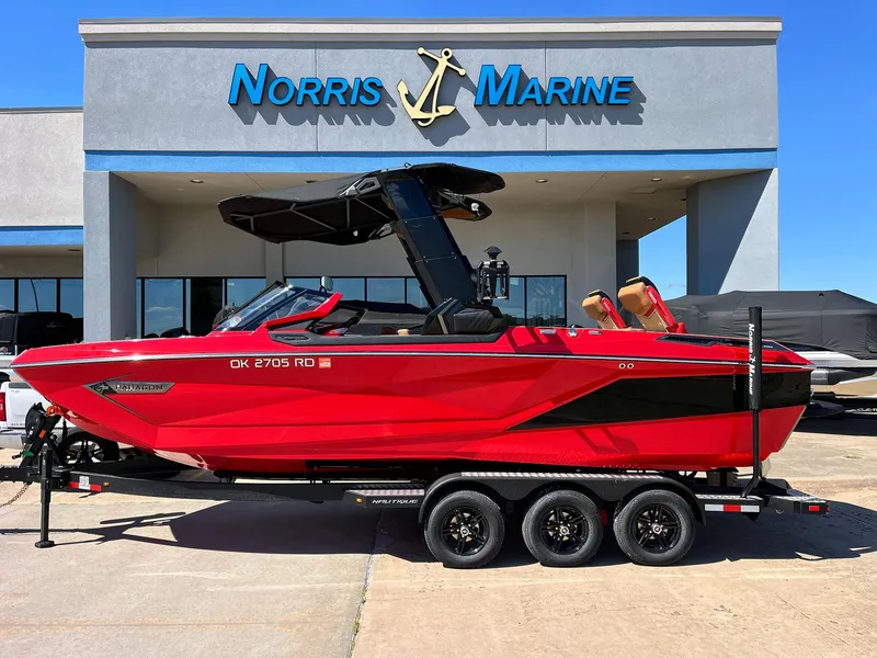 Slide: The Image of 2021 Nautique Super Air Nautique G25 Paragon in red, parked at Norris Marine dealership. - 1