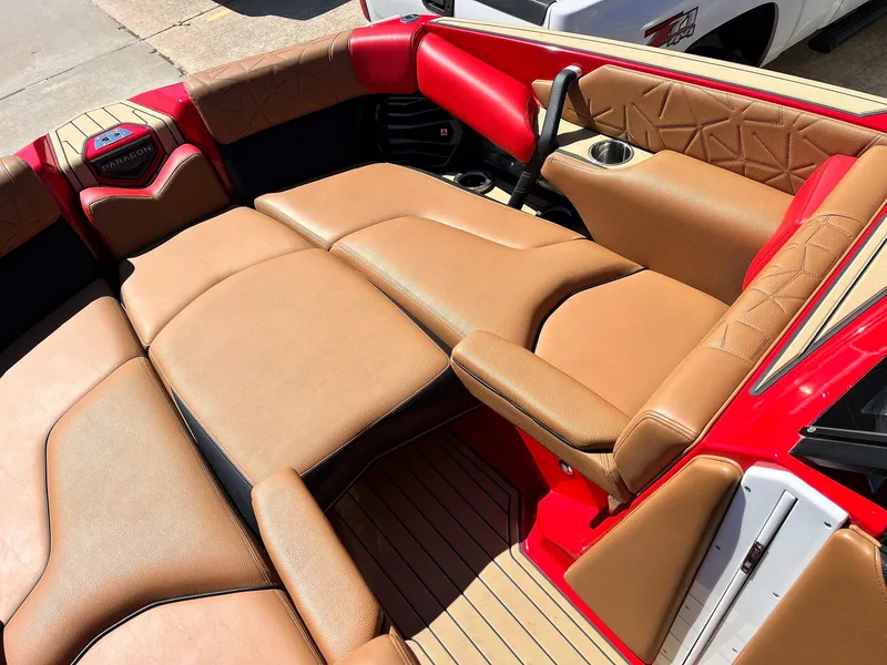 Slide: The Image of 2021 Nautique Super Air Nautique G25 Paragon interior with tan leather seats and red accents. - 11
