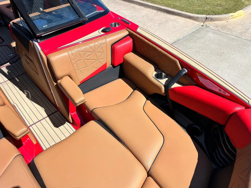 Slide: The Image of 2021 Nautique Super Air Nautique G25 Paragon interior with tan and red upholstery. - 12