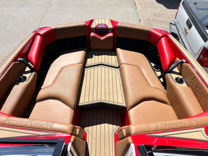 Slide: The Image of 2021 Nautique Super Air Nautique G25 Paragon boat interior with tan and red seating. - 14