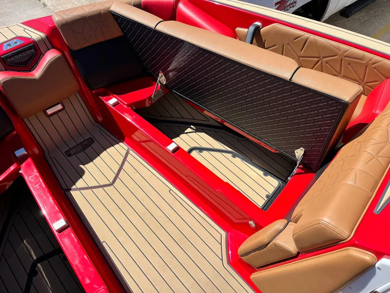Slide: The Image of 2021 Nautique Super Air Nautique G25 Paragon interior with red and tan seating, open storage. - 17