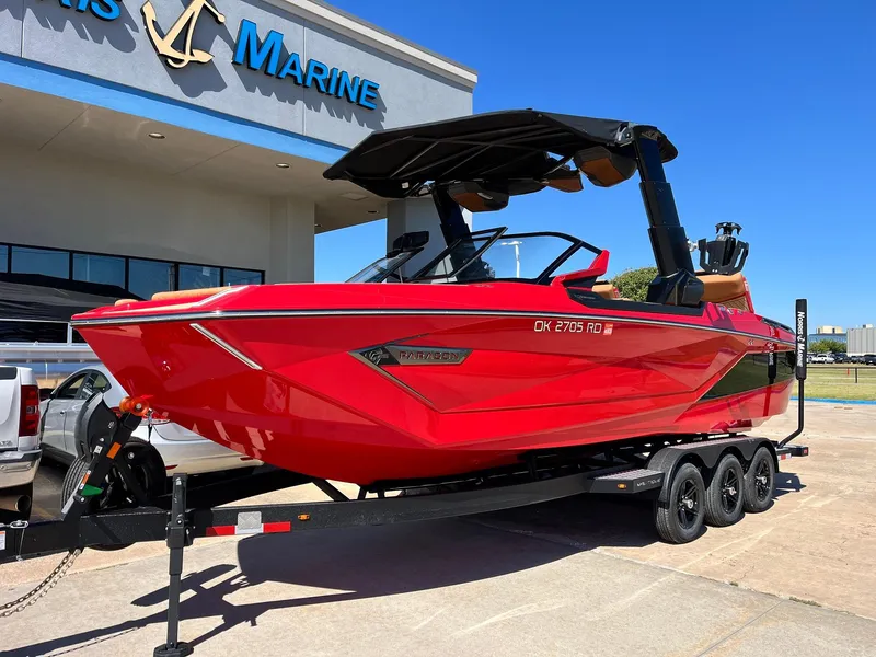 Slide: The Image of 2021 Nautique Super Air Nautique G25 Paragon boat in vibrant red on a trailer. - 2