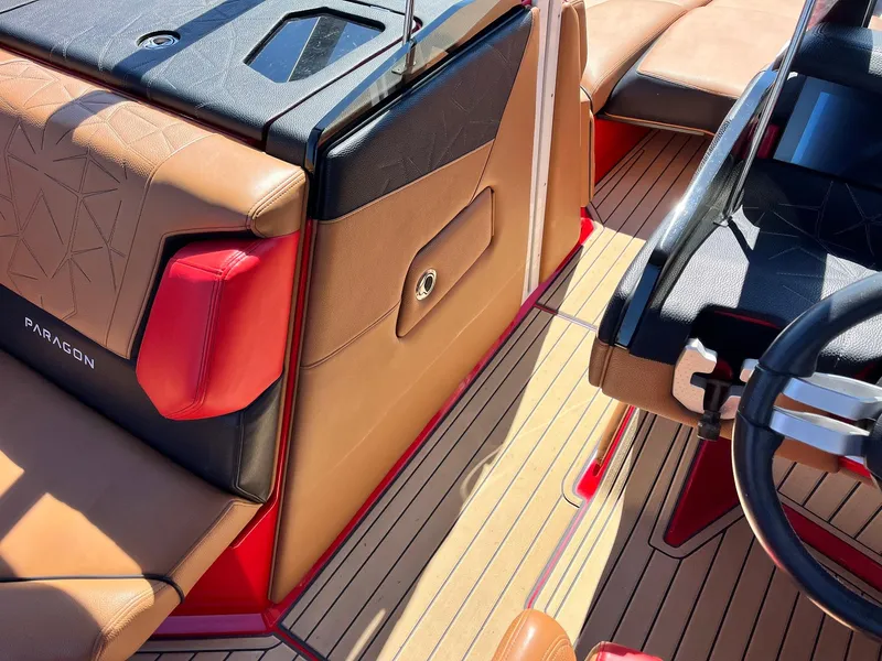 Slide: The Image of 2021 Nautique Super Air Nautique G25 Paragon interior with brown and red leather seating. - 23