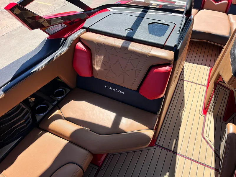 Slide: The Image of 2021 Nautique Super Air Nautique G25 Paragon interior with tan and red seating. - 25