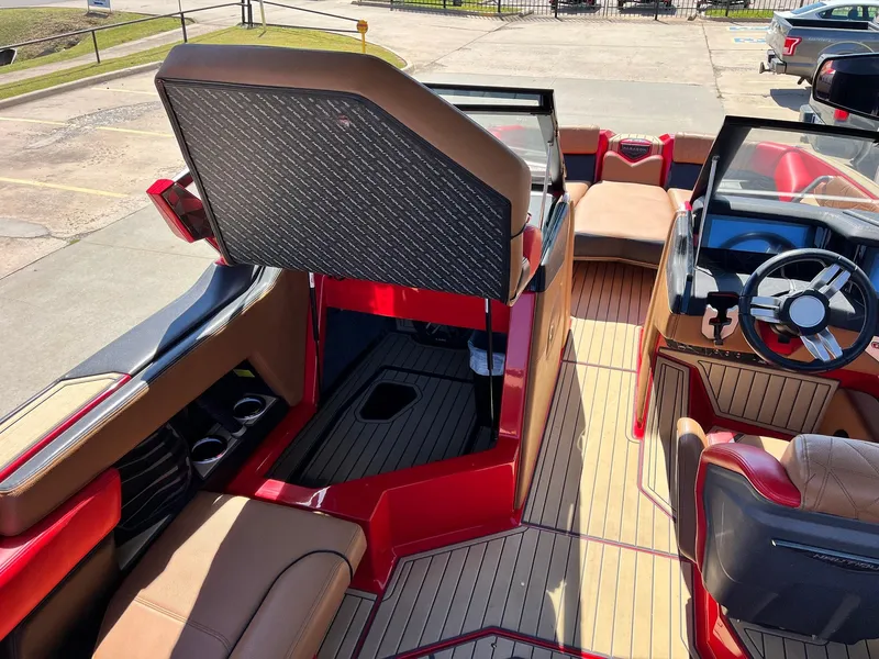Slide: The Image of Interior of 2021 Nautique Super Air Nautique G25 Paragon boat, featuring luxurious seating and steering wheel. - 26