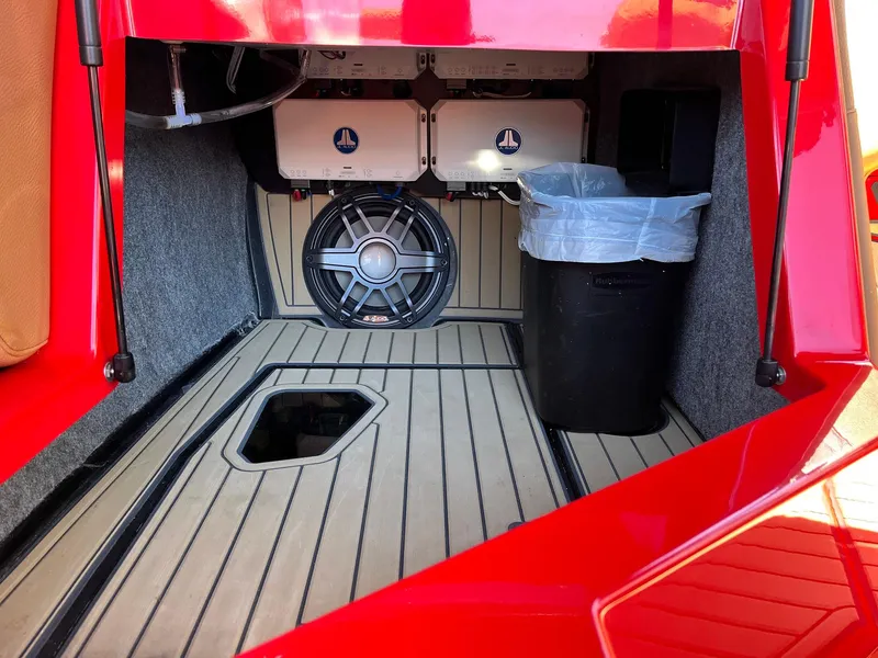Slide: The Image of 2021 Nautique Super Air Nautique G25 Paragon interior storage with speaker and trash bin. - 27