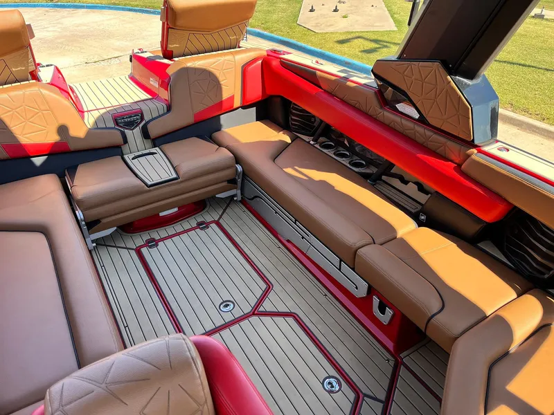 Slide: The Image of Luxurious interior of 2021 Nautique Super Air Nautique G25 Paragon with tan and red seating. - 28
