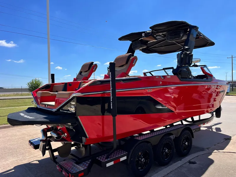 Slide: The Image of 2021 Nautique Super Air Nautique G25 Paragon boat in vibrant red on a trailer. - 3