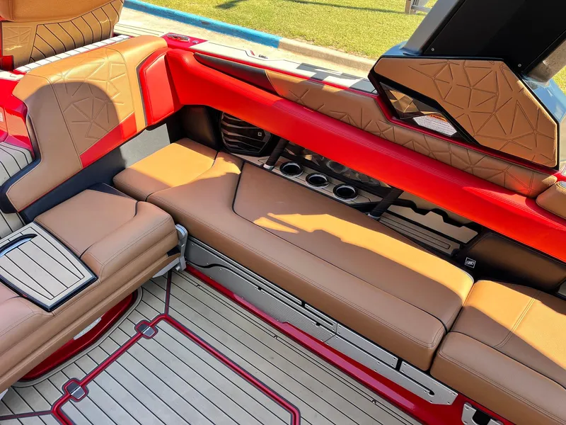Slide: The Image of Luxurious interior of 2021 Nautique Super Air Nautique G25 Paragon with tan and red seating. - 30