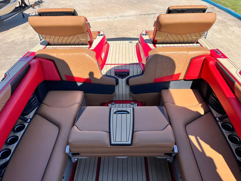 Slide: The Image of 2021 Nautique Super Air Nautique G25 Paragon interior with tan and red seating, cup holders. - 33