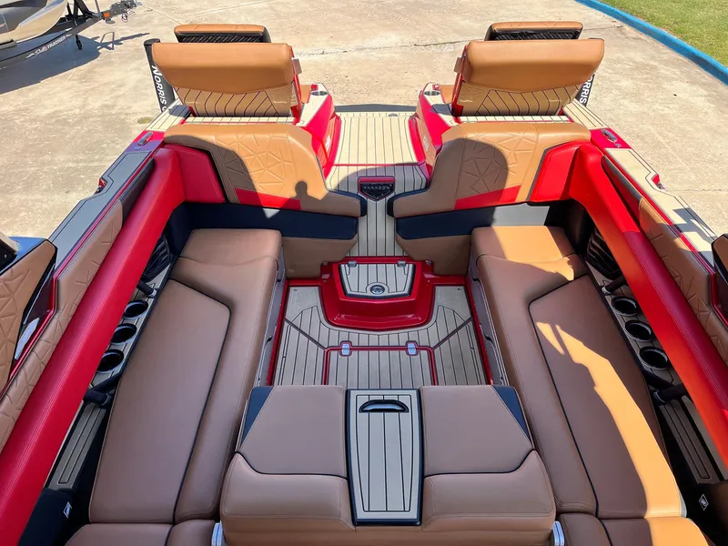 Slide: The Image of Luxurious interior of 2021 Nautique Super Air Nautique G25 Paragon boat with red and tan seating. - 34