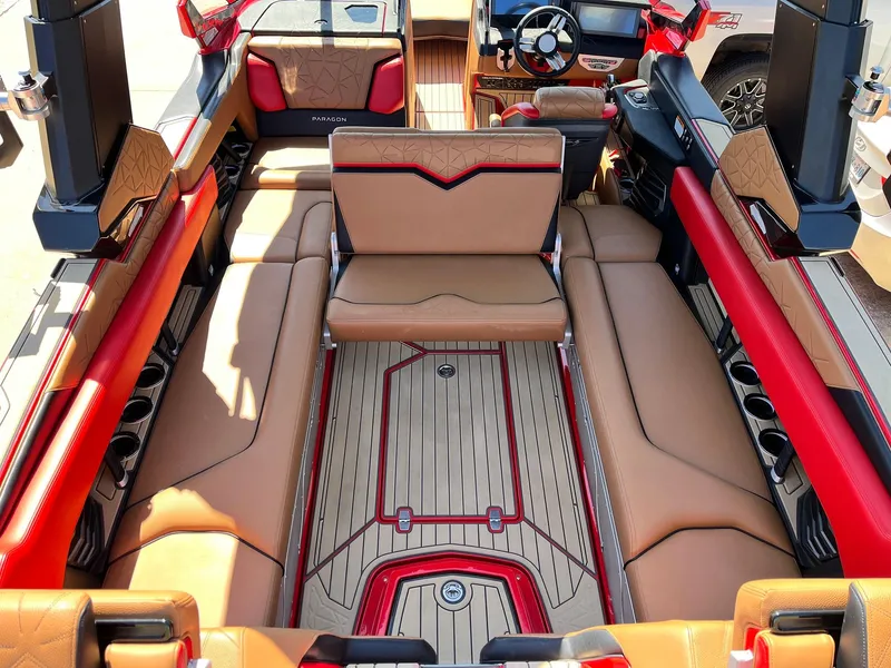 Slide: The Image of Luxurious interior of 2021 Nautique Super Air Nautique G25 Paragon boat with tan and red seating. - 35