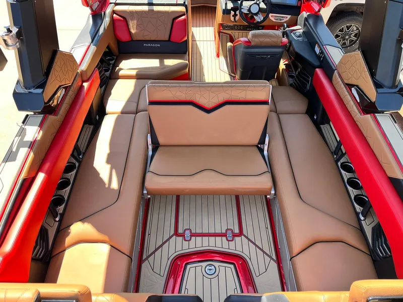 Slide: The Image of Luxurious interior of 2021 Nautique Super Air Nautique G25 Paragon boat with tan and red seating. - 36