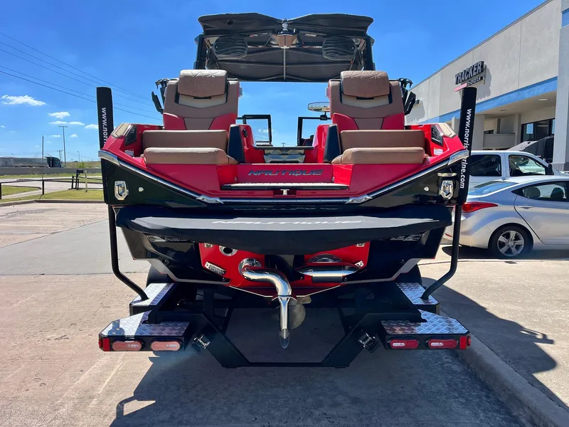 Slide: The Image of 2021 Nautique Super Air Nautique G25 Paragon boat, rear view, red and black design. - 4