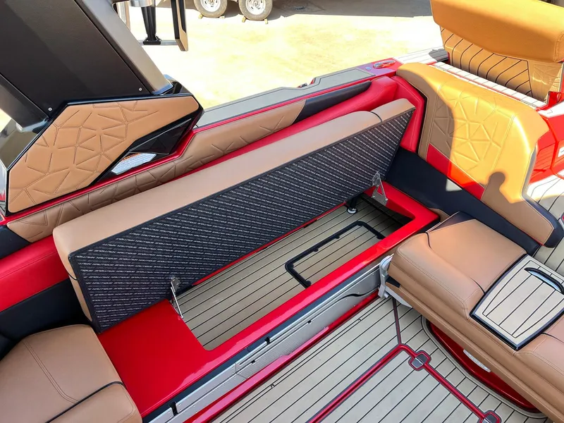 Slide: The Image of 2021 Nautique Super Air Nautique G25 Paragon interior with open storage compartment, tan and red upholstery. - 40