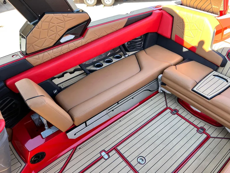 Slide: The Image of Luxurious interior of 2021 Nautique Super Air Nautique G25 Paragon with tan and red seating. - 41