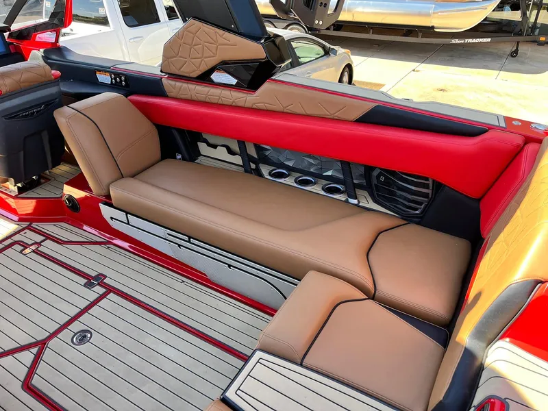 Slide: The Image of 2021 Nautique Super Air Nautique G25 Paragon interior with tan and red seating. - 42