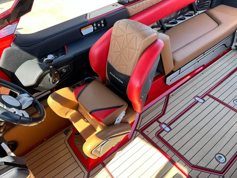 Slide: The Image of 2021 Nautique Super Air Nautique G25 Paragon interior with red and tan seating, luxury design. - 44