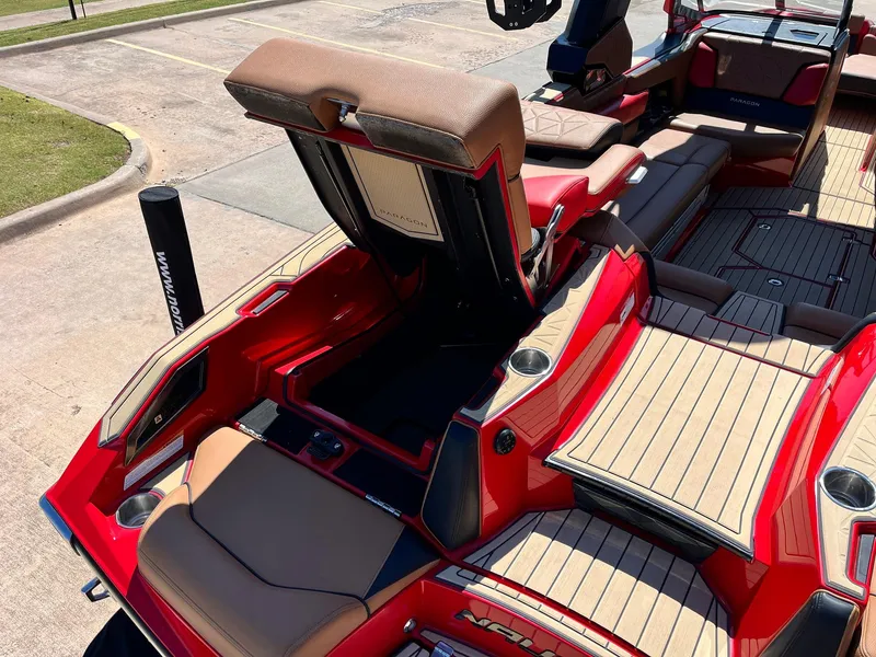 Slide: The Image of 2021 Nautique Super Air Nautique G25 Paragon interior with red and tan seating, open storage. - 49