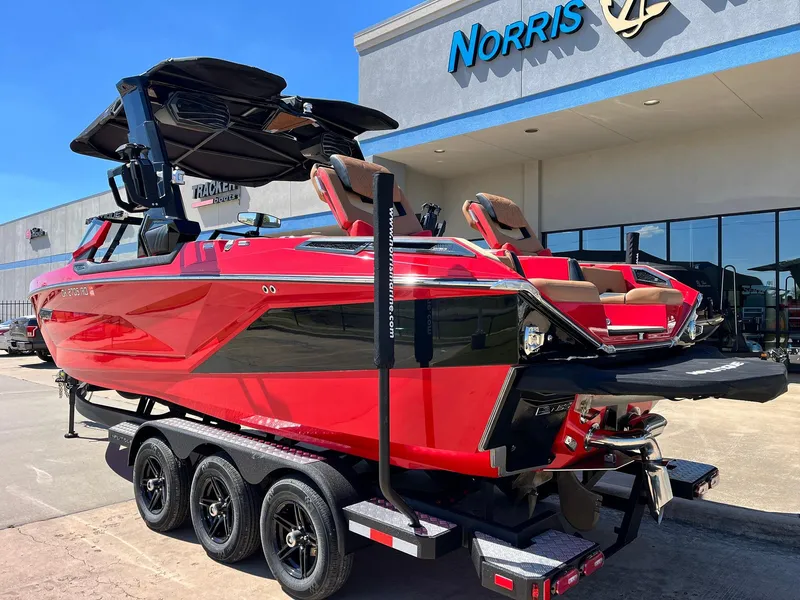 Slide: The Image of 2021 Nautique Super Air Nautique G25 Paragon boat in vibrant red on a trailer. - 5