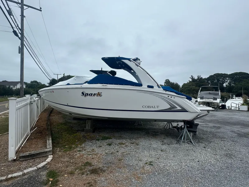 The Image of 2020 Cobalt R5 Surf boat on display in a parking area. - 0