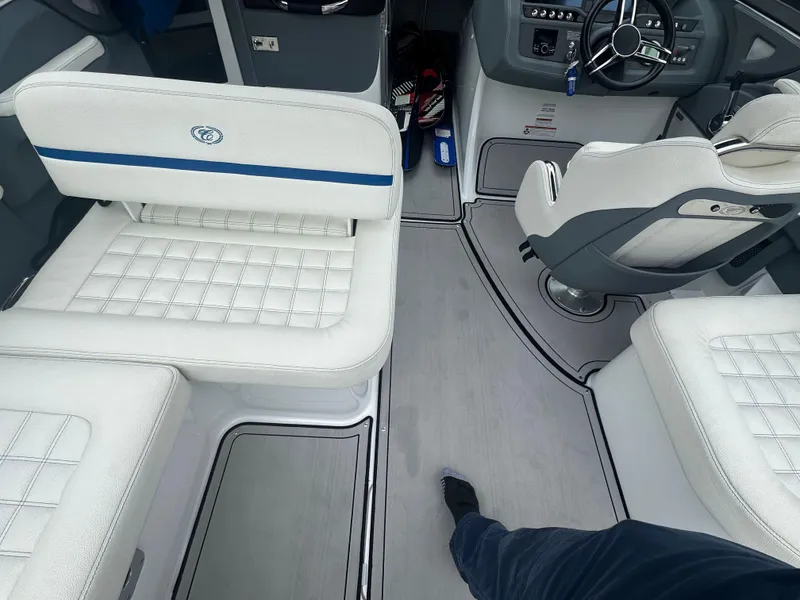 Slide: The Image of Interior of 2020 Cobalt R5 Surf boat with white seating and modern dashboard. - 4
