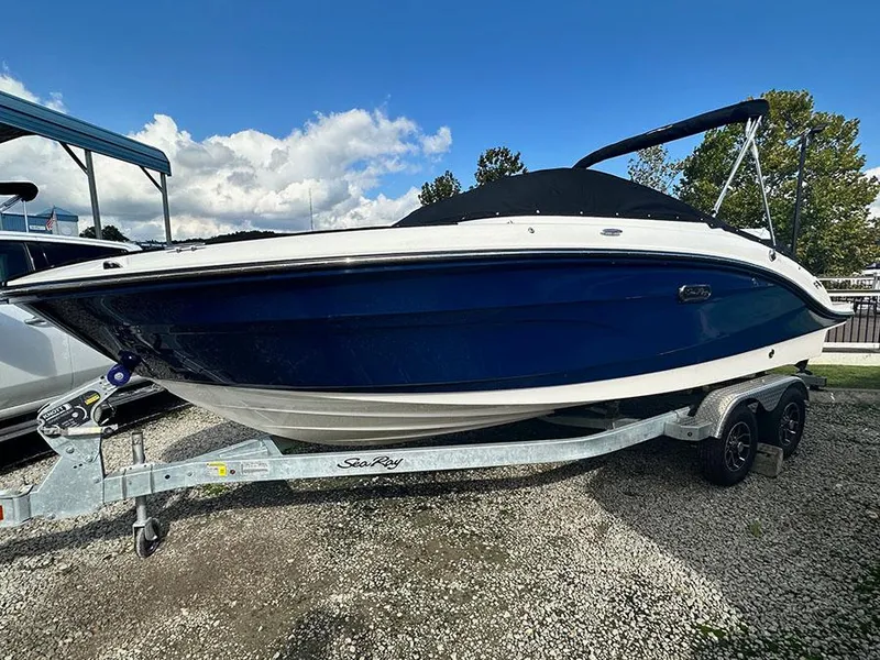 The Image of 2025 Sea Ray SPO 210 boat on trailer under blue sky. - 0