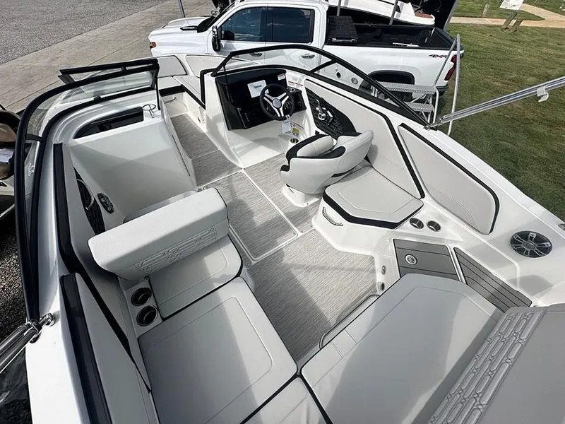 Slide: The Image of 2025 Sea Ray SPO 210 boat interior with modern seating and steering wheel. - 3