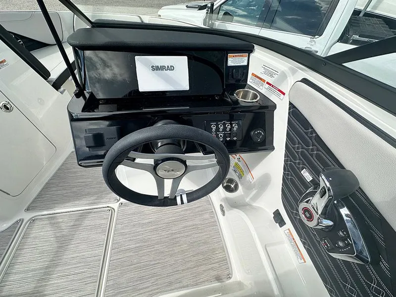 Slide: The Image of 2025 Sea Ray SPO 210 boat dashboard with steering wheel and Simrad display. - 4